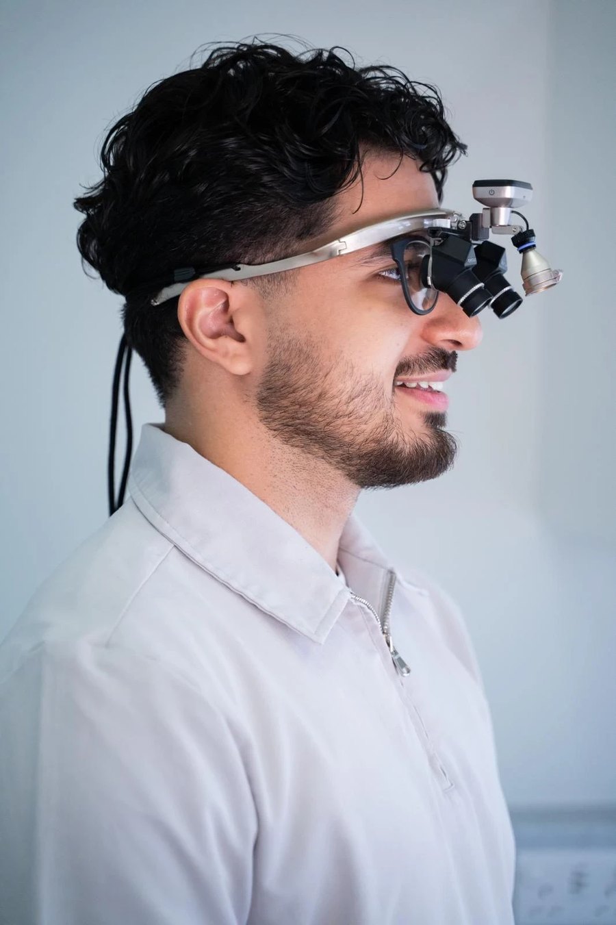 A clinician wearing PENTAX Loupes, fitted to them